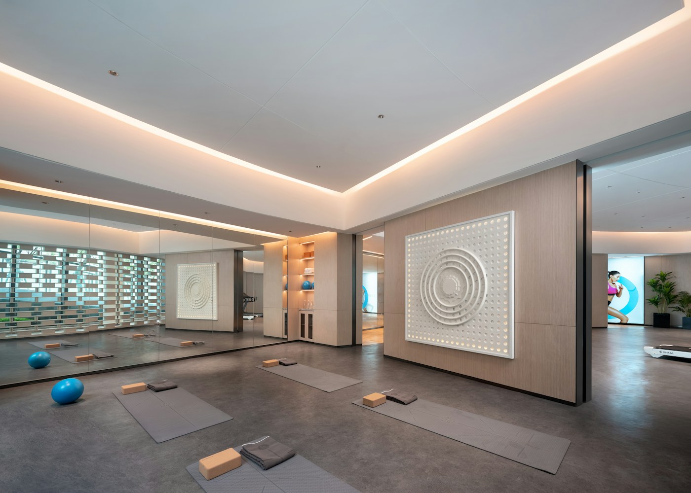Warm modern fitness studio with mats and soft lighting